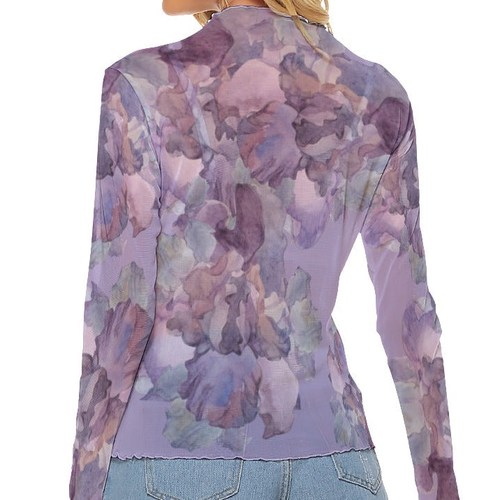 Woman wearing a purple floral long-sleeve top on a white background