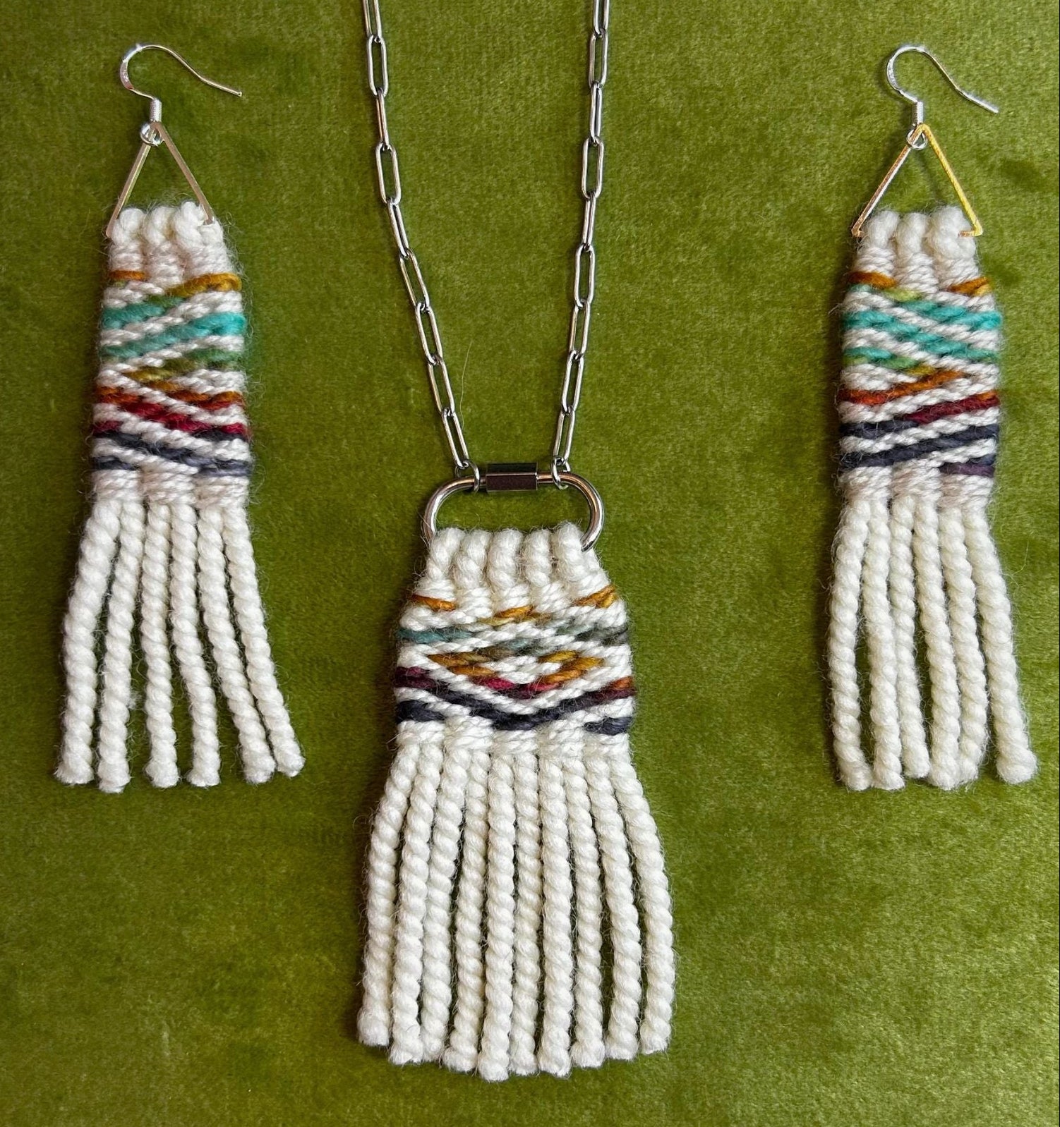 Necklace and earrings with woven design on a green background