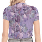Person wearing a short-sleeve top with a floral pattern and high-waisted jeans on a white background